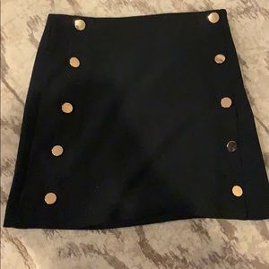 Black miniskirt with gold buttons